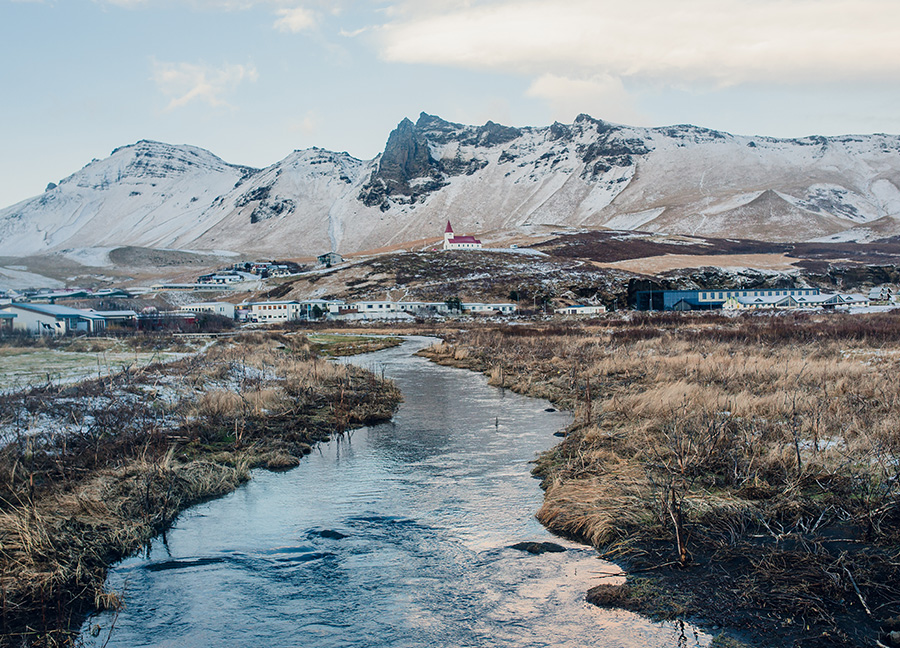 Mountainous landscape image with a winding river in the foreground.