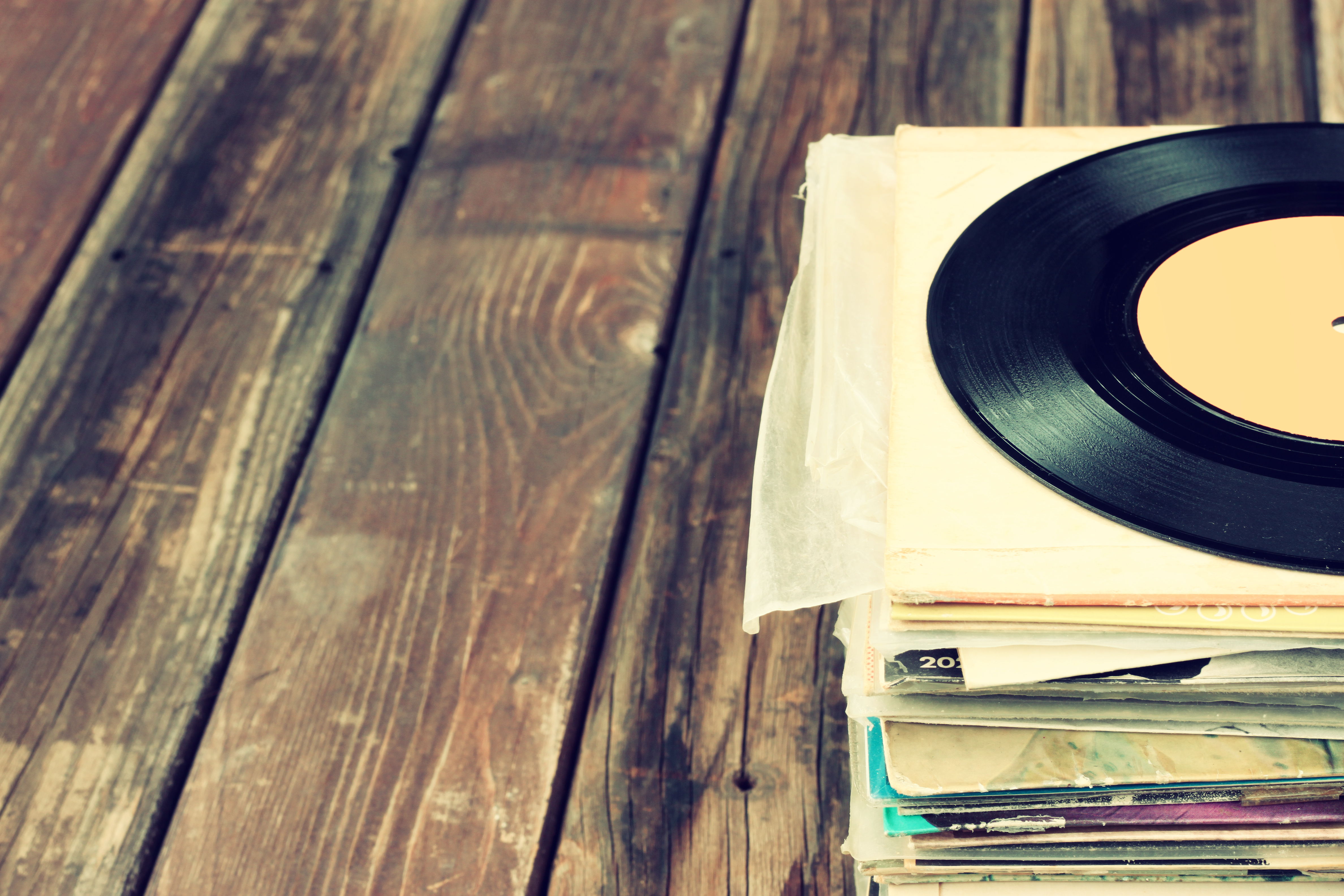 vinyl records stacked on floor