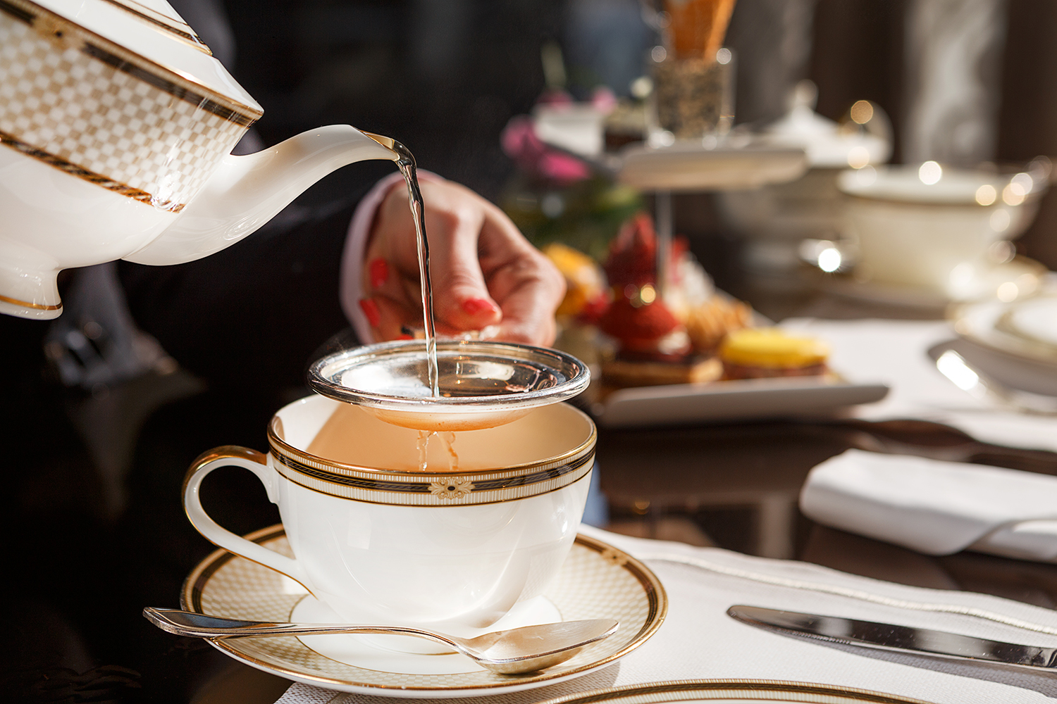 tea being poured in china tea cup
