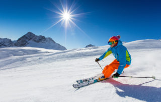 downhill skier in sunshine